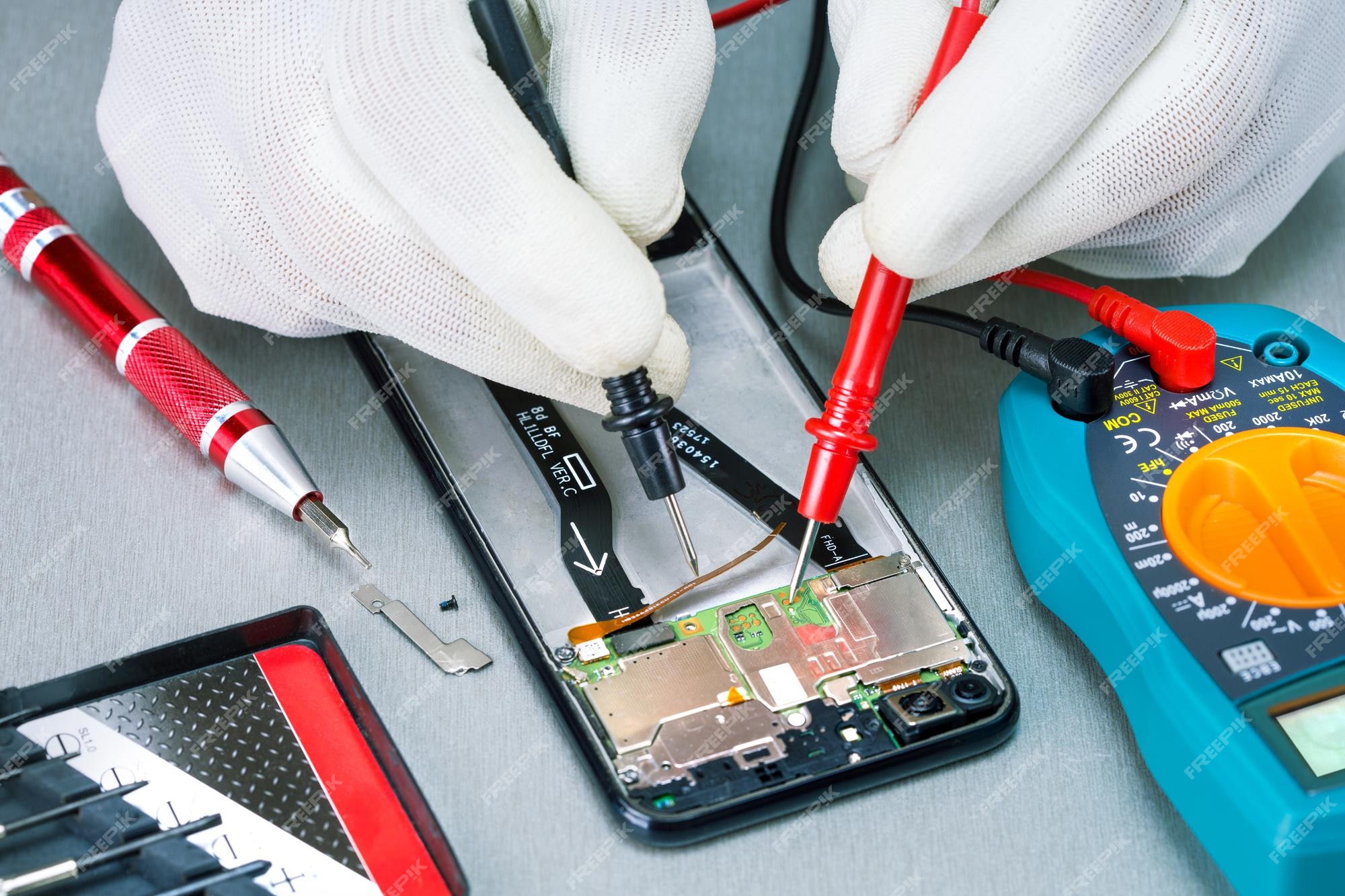 repairing smartphone with multimeter lab checking damaged mobile phone with digital multimeter 106035 1403